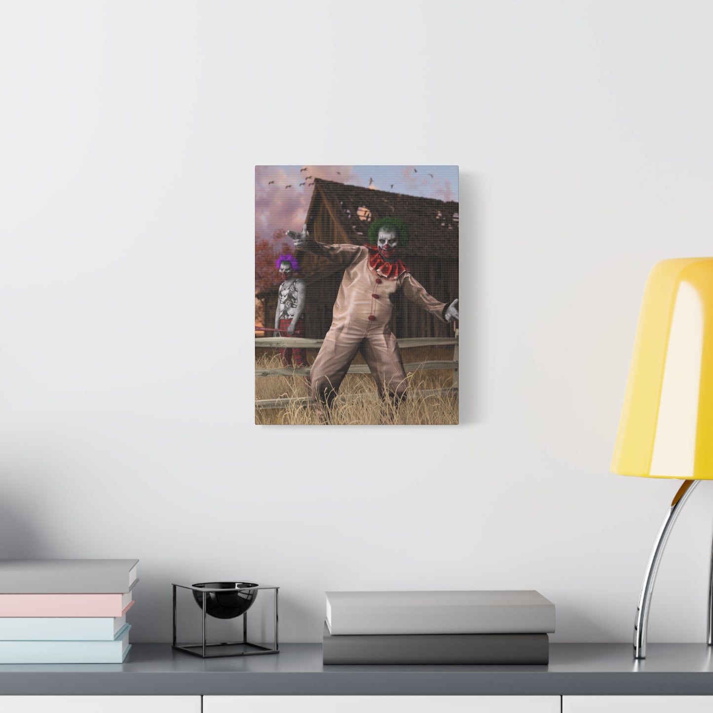 A rectangular wall art print showing a clown-like figure in a barn scene, displayed on a light gray wall above a shelf with books and a yellow lamp.