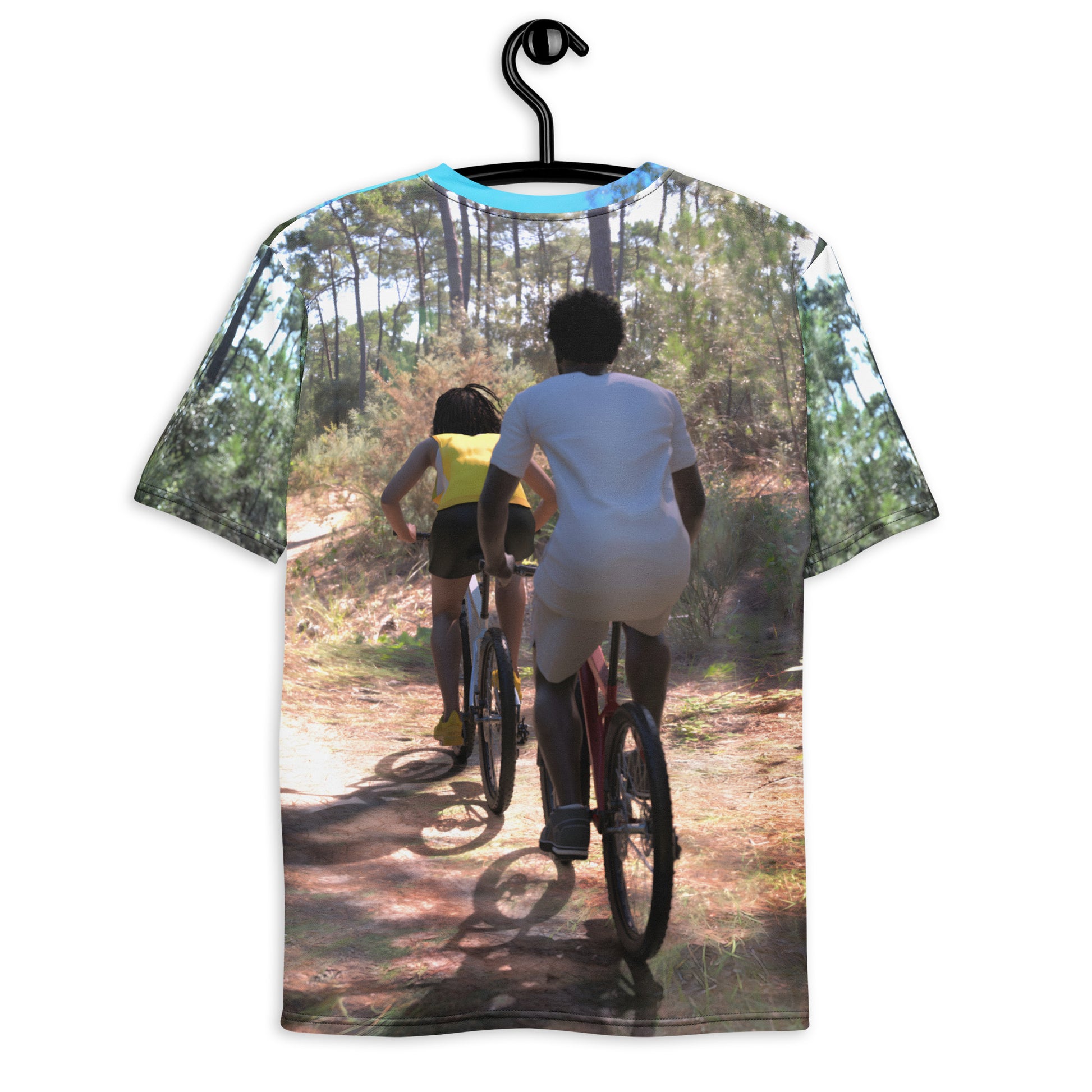 An all over print t-shirt of a black man and woman riding bicycles on a trail in the woods.