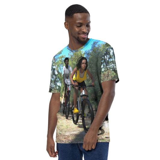 An all over print t-shirt of a black man and woman riding bicycles on a trail in the woods.