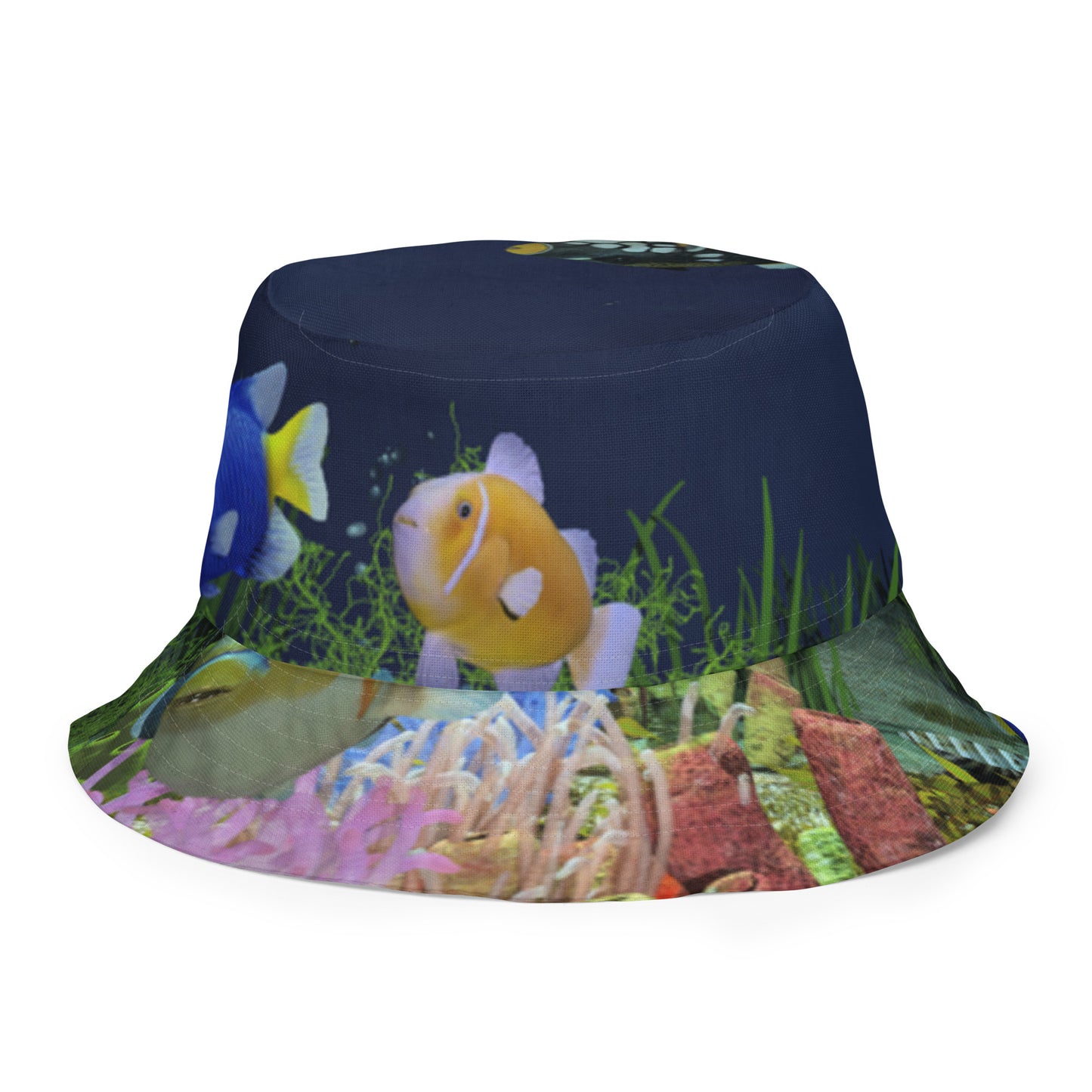A reversible bucket hat with an image of dark ocean water with fish and a coral reef underwater.