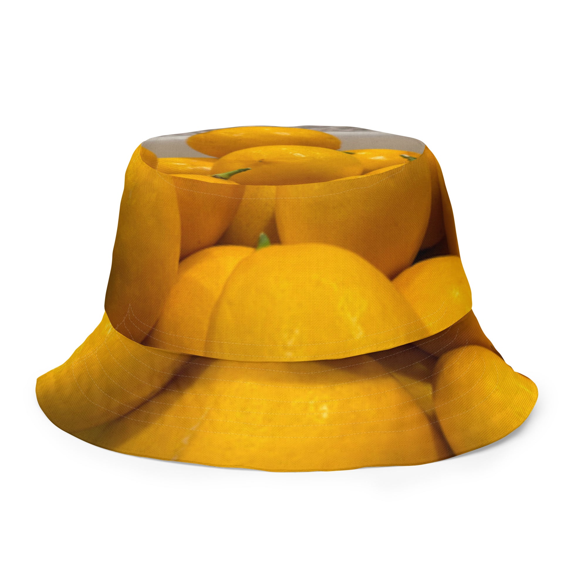 A reversible bucket hat with an image of lemons and a lemon meringue pie.