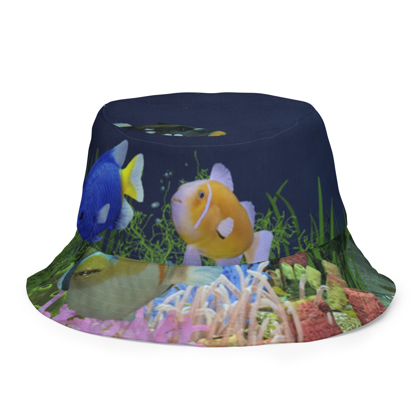 A reversible bucket hat with an image of dark ocean water with fish and a coral reef underwater.
