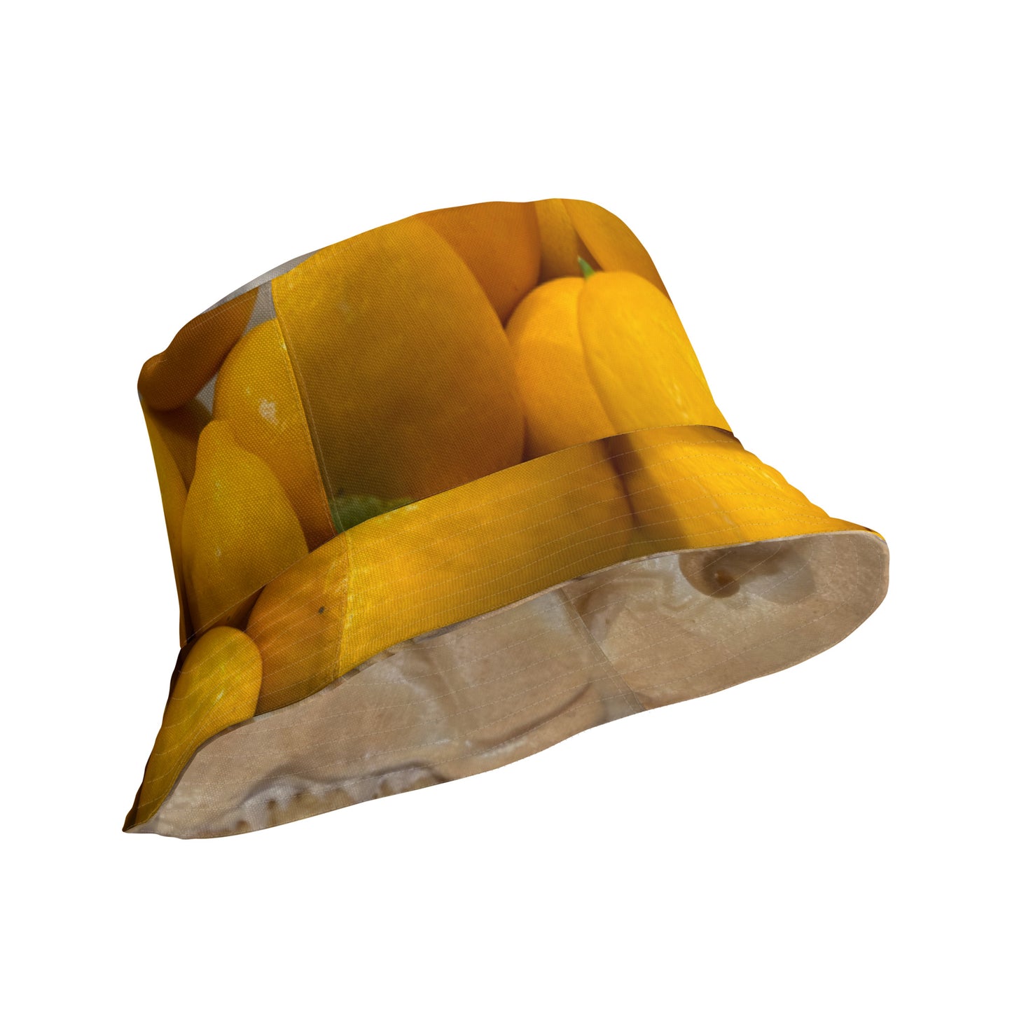 A reversible bucket hat with an image of lemons and a lemon meringue pie.