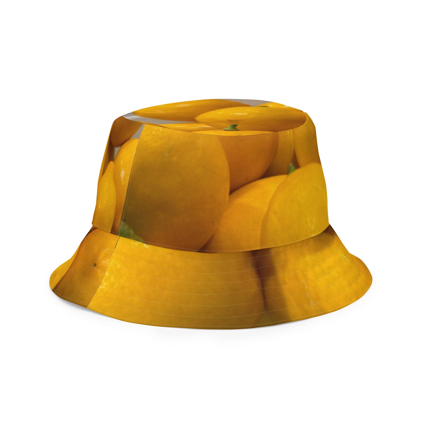 A reversible bucket hat with an image of lemons and a lemon meringue pie.