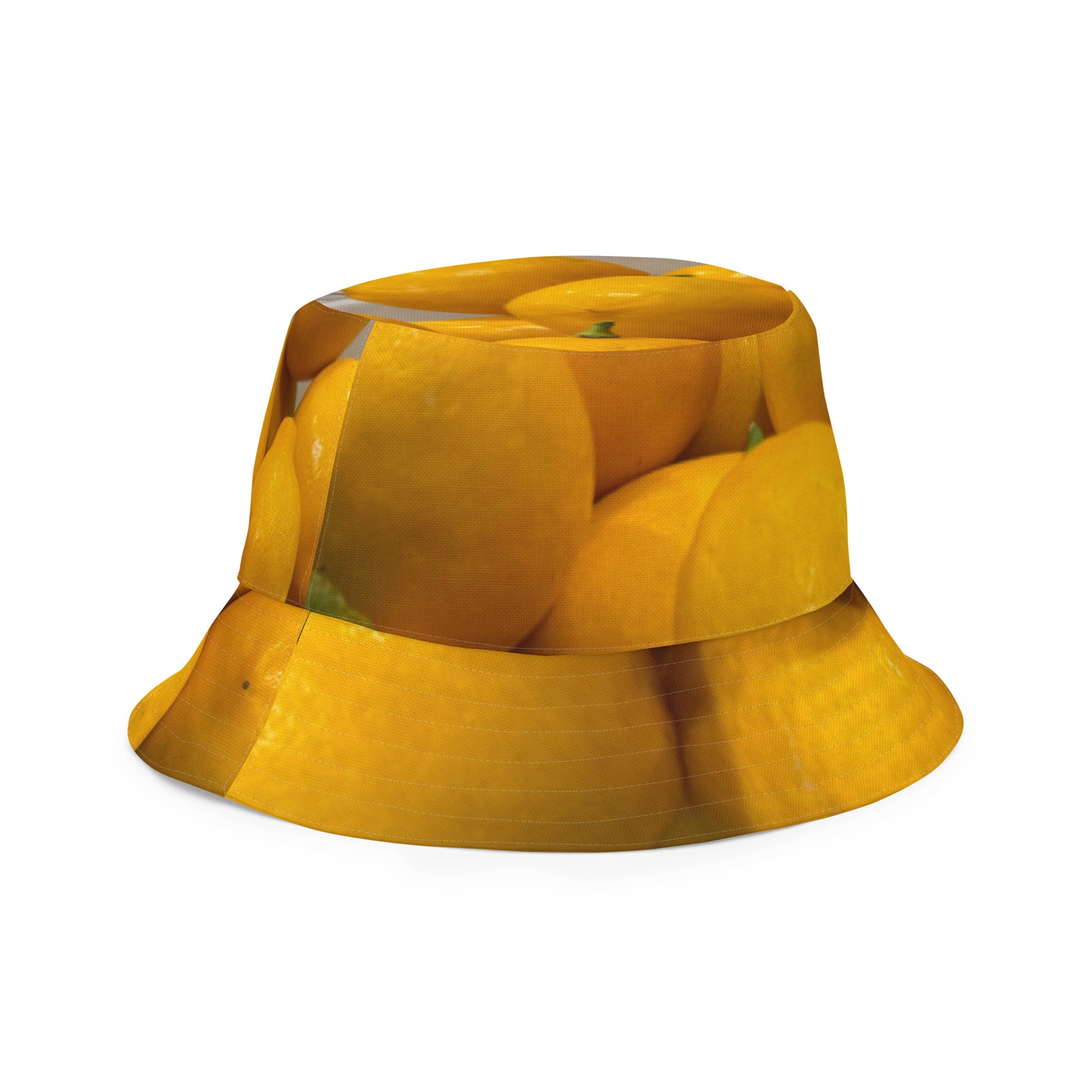 A reversible bucket hat with an image of lemons and a lemon meringue pie.