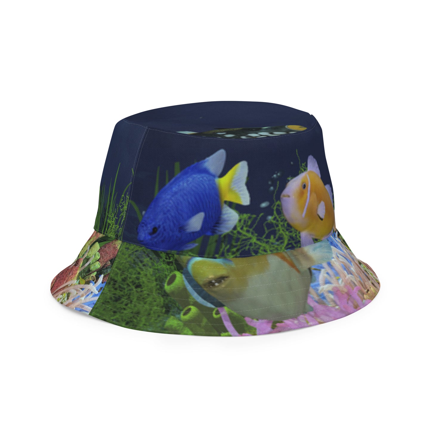 A reversible bucket hat with an image of dark ocean water with fish and a coral reef underwater.