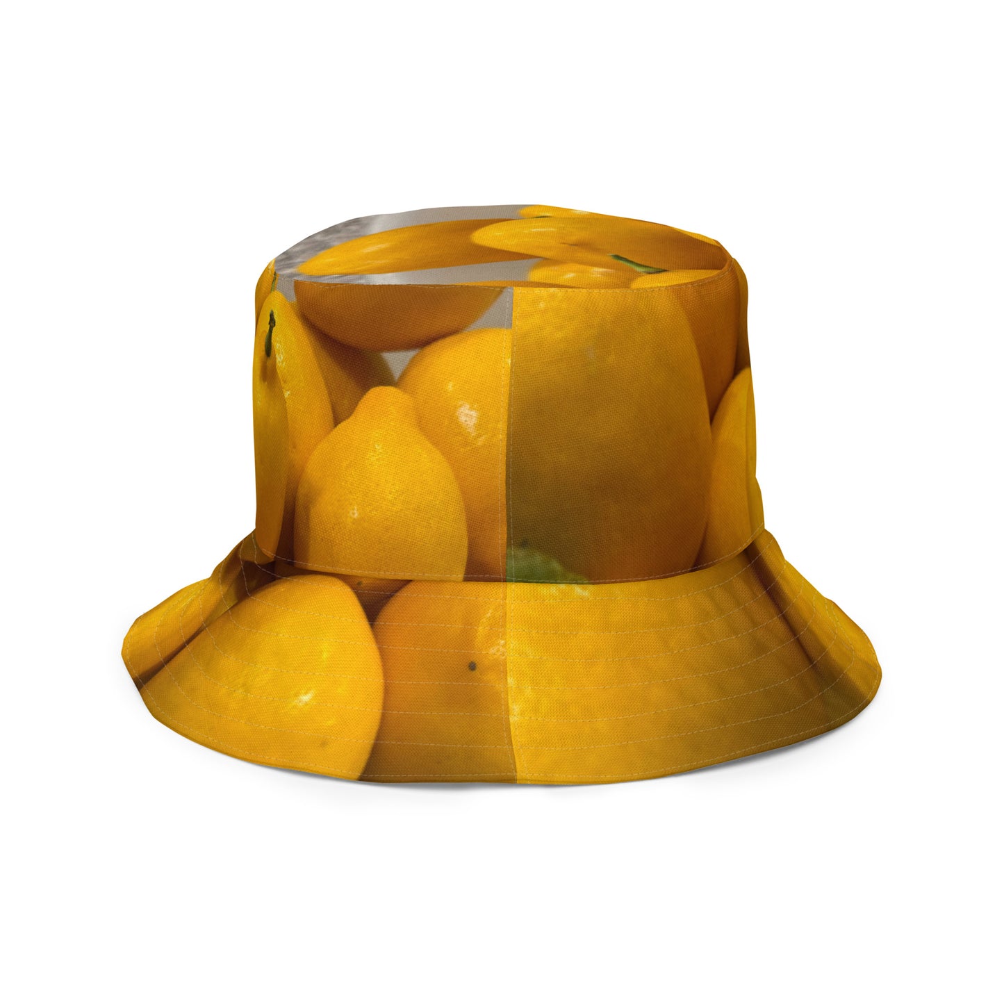 A reversible bucket hat with an image of lemons and a lemon meringue pie.